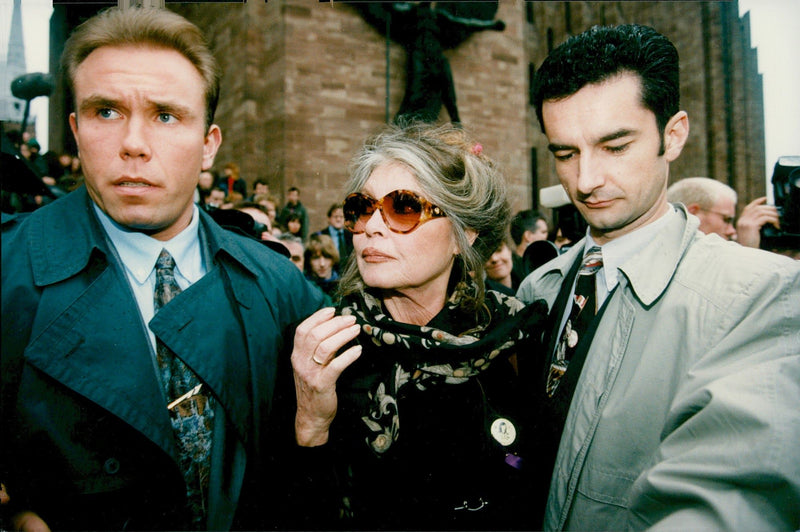 Brigitte Bardot, with two bodyguards, attending animal rights activist Jill Phipps funeral - Vintage Photograph