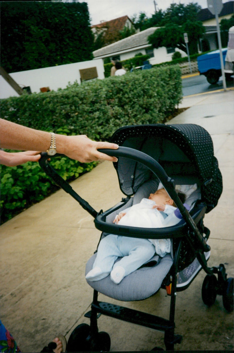 Kevin Costner's love child with Bridget Rooney in a stroller during a sunny stroll in Miami - Vintage Photograph
