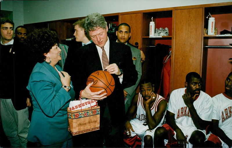 Bill Clinton writes autograph on a basketball - Vintage Photograph