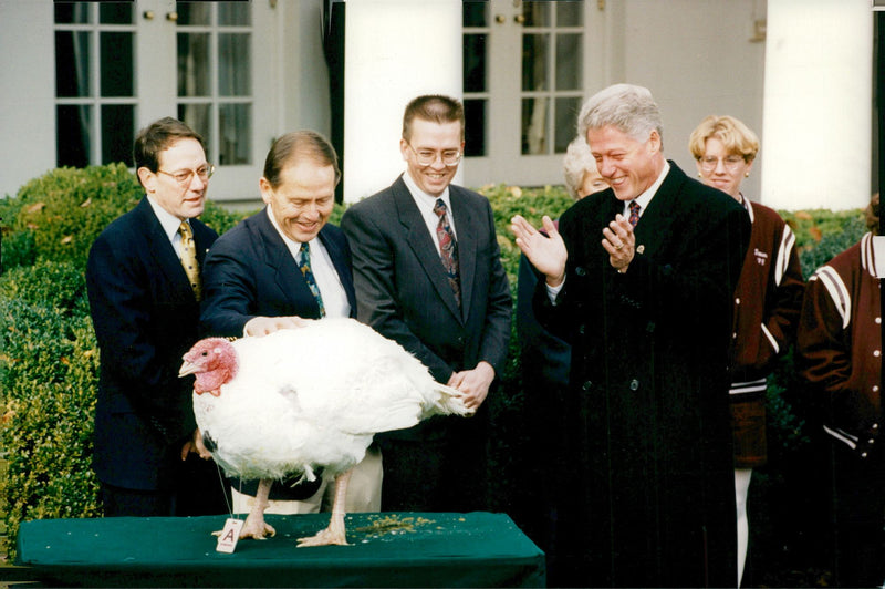 US President Bill Clinton receives a turkey from the president of the &quot;National Turkey Federation&quot;, Jim Cooper - Vintage Photograph