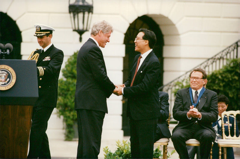 Bill Clinton submits the medal "National Medal of the Arts" to Yo-Yo Ma outside White House - Vintage Photograph