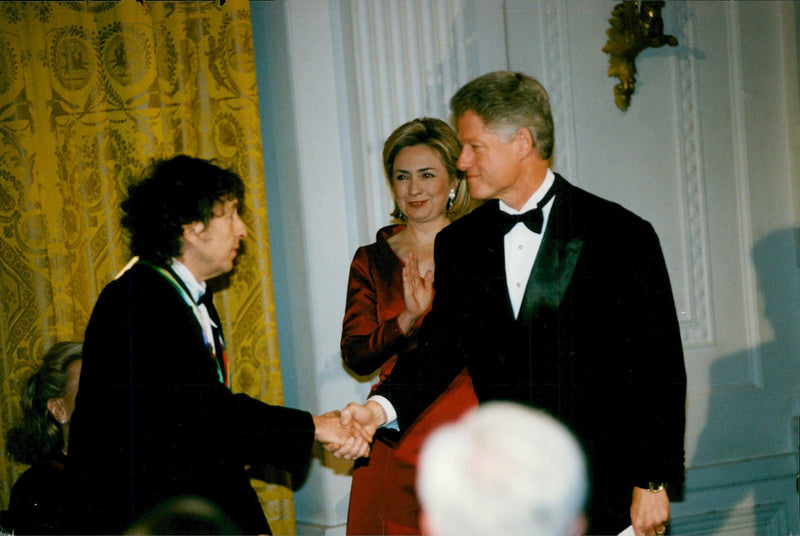 President Bill Clinton shakes hands with Bod Dylan at an awards ceremony at the Kennedy Center - Vintage Photograph