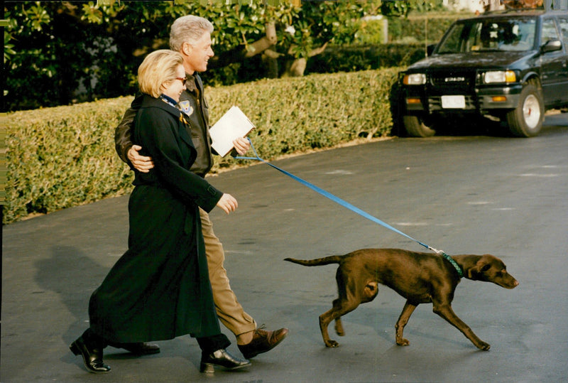 Bill and Hillary Clinton walking the family dog - Vintage Photograph