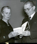 Mrs. S. regards with red. A. SvÃ¤rd&#39;s deceased husband&#39;s book &quot;White Man in Black Country&quot; at the Swedish Baptist Mission&#39;s Annual Conference in the Concert Hall - 12 June 1942 - Vintage Photograph