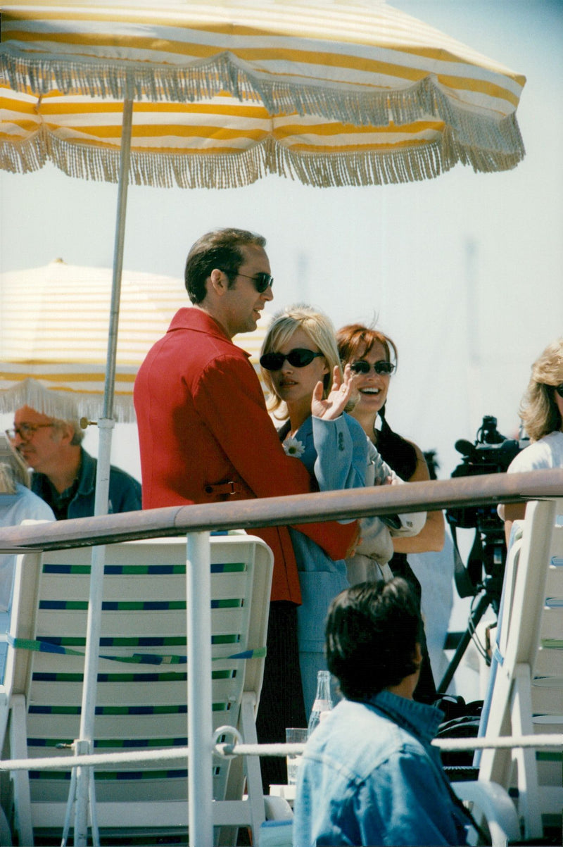 Newlyweds Patricia Arquette and Nicolas Cage cuddling at the beach - Vintage Photograph