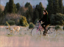 Princess Caroline of Monaco bicycles in the countryside with her two dogs. - Vintage Photograph