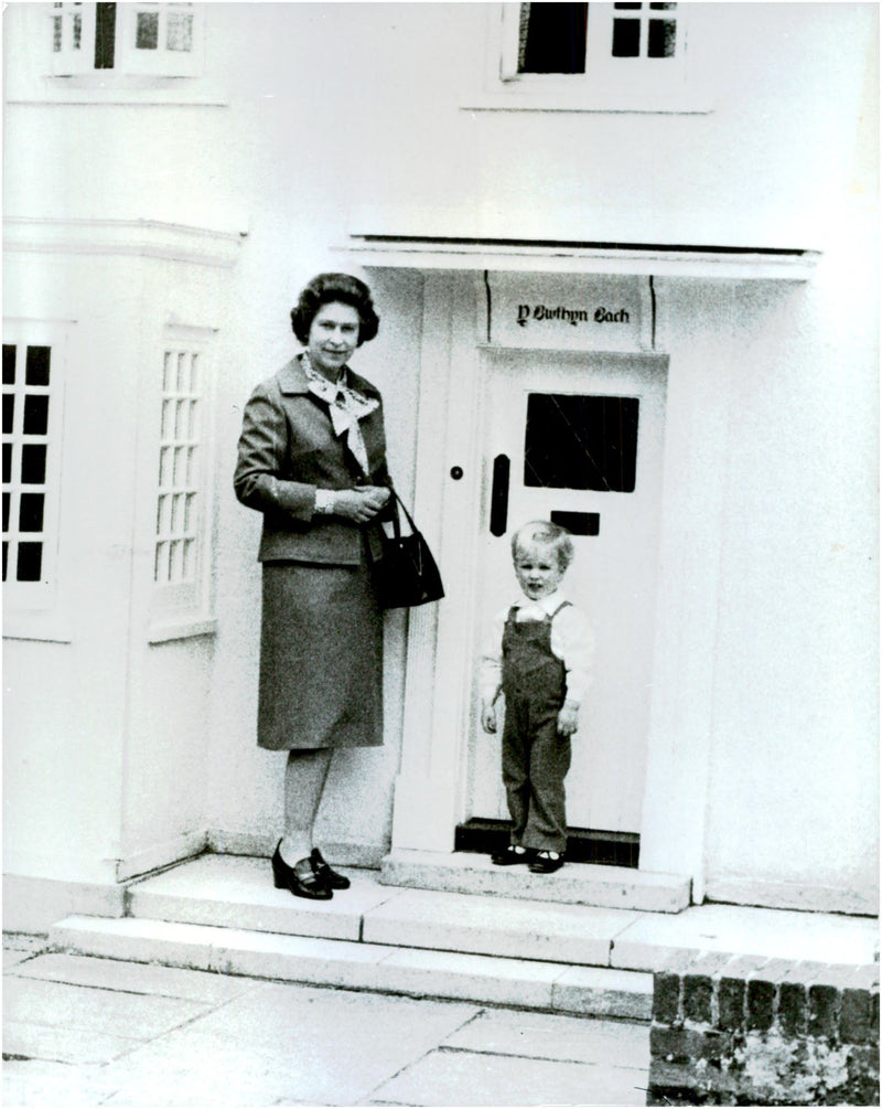 Elizabeth II along with the grandchild Peter Phillips on his way into the miniature cottage - Vintage Photograph