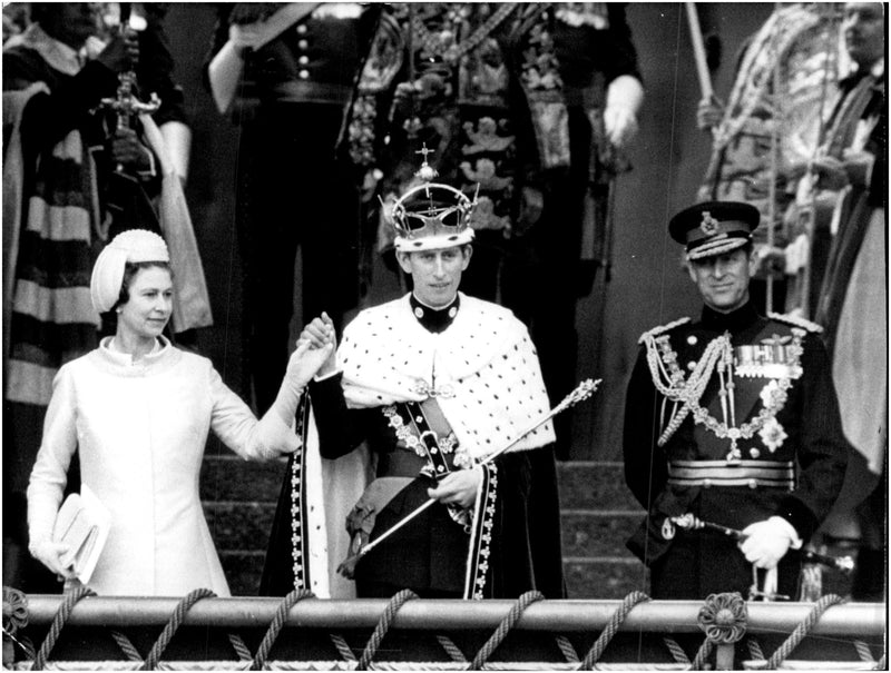 Queen Elizabeth II presents her son, Prince Charles of Wales, outside Caernarfon Castle. - Vintage Photograph