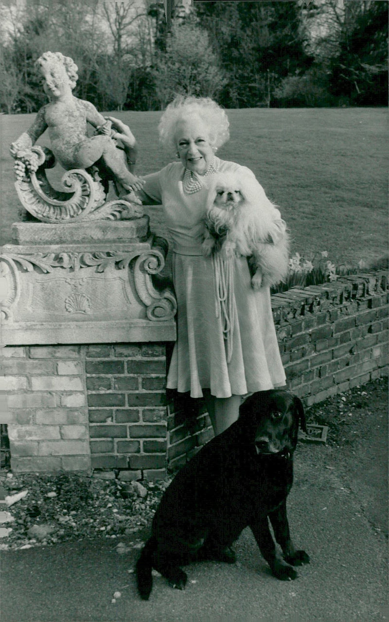 Barbara Cartland out in the garden with her two dogs - Vintage Photograph