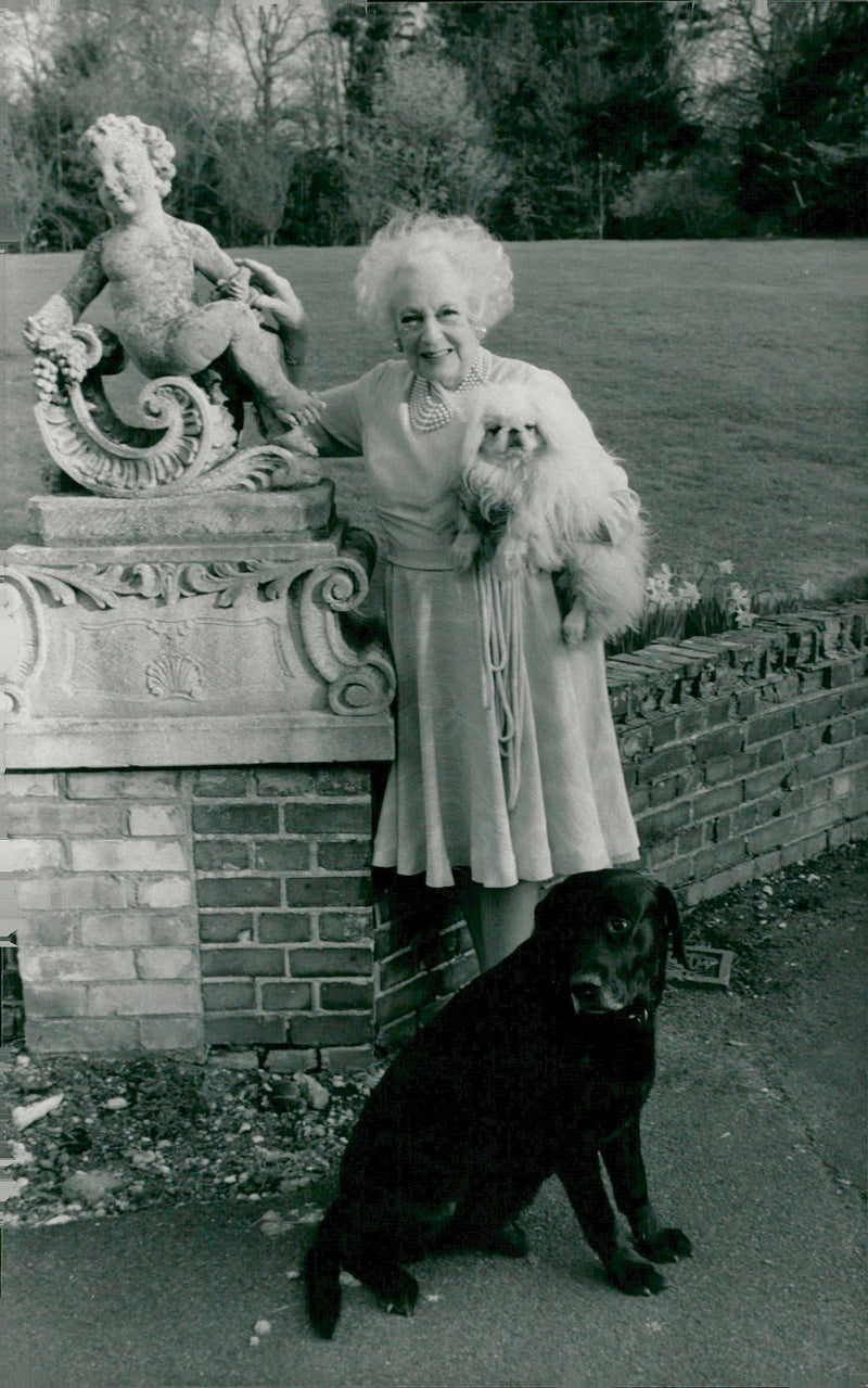 Barbara Cartland out in the garden with her two dogs - Vintage Photograph