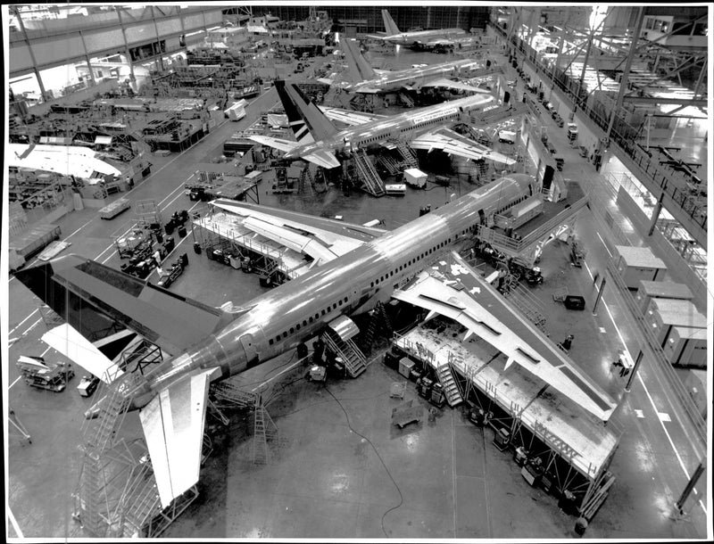 A Boeing 757 during assembly of Boeing's huge manufacturing building. - Vintage Photograph