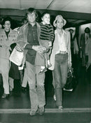 Kris Kristofferson and Rita Coolidge with their daughter Casey when they arrive for a tour. - Vintage Photograph
