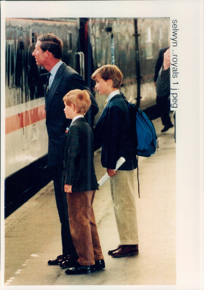 Prince Charles and his sons Prince William and Harry, at a train station. - Vintage Photograph