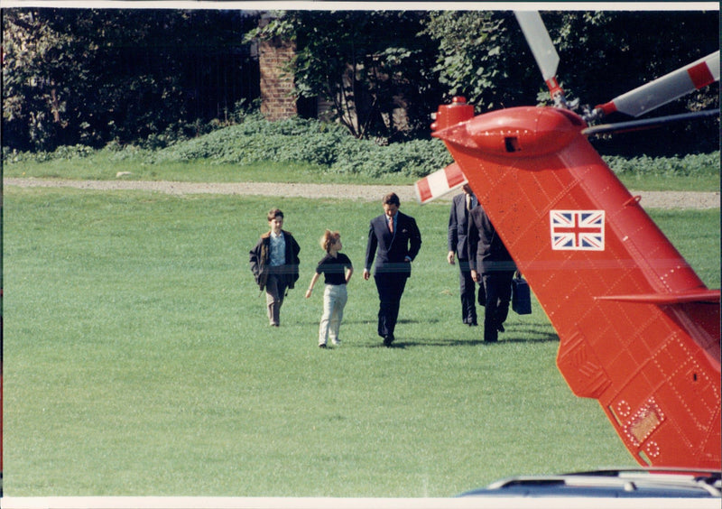 Prince Charles is going to fly to Sutton, Coldfield. Here are his two sons, the prince Harry and William, following him to the flight. - Vintage Photograph