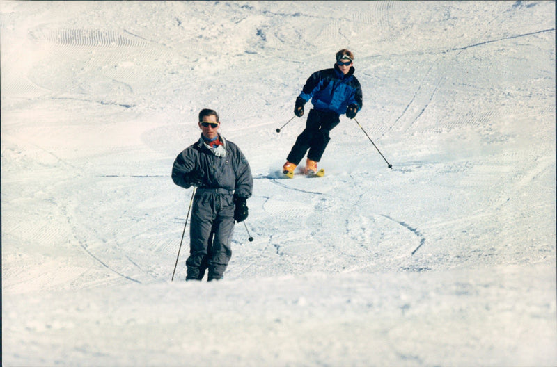 Prince Charles and his son, Prince Harry, go skiing at the luxurious ski resort Klosters, Switzerland. - Vintage Photograph