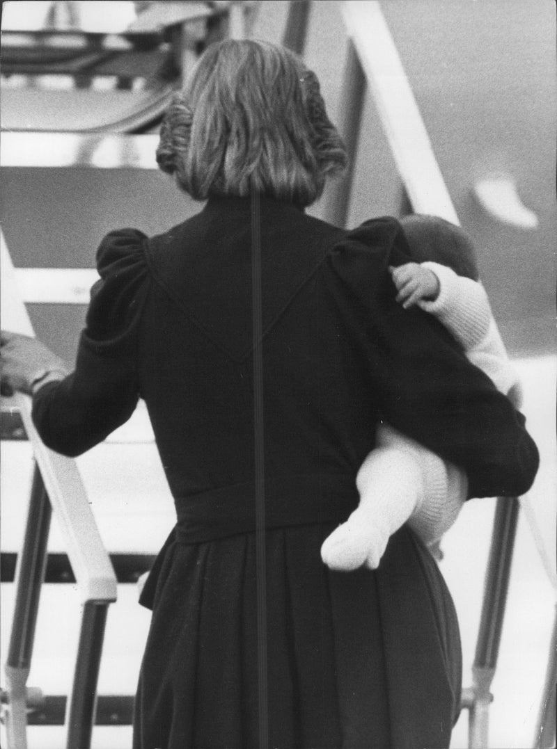Princess Diana carries on her son, Prince William. They are heading back to London after a holiday in Balmoral, Scotland. Aberdeen Airport. - Vintage Photograph