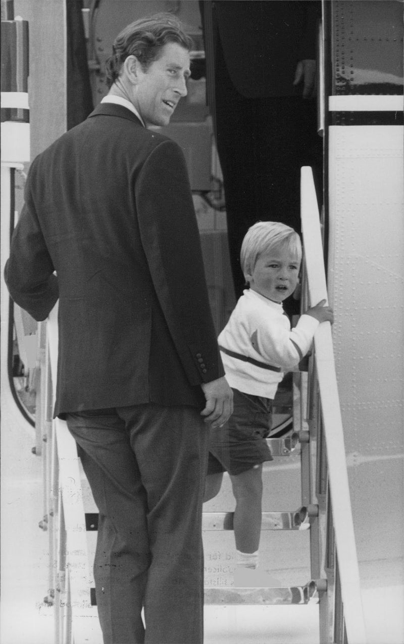 Prince Charles and Prince William step on the plane to fly back to London from Scotland. - Vintage Photograph
