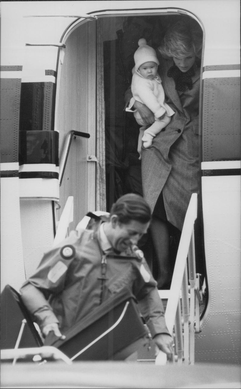 Prince Charles and Princess Diana with Prince Harry in the family arrive after a trip. - Vintage Photograph