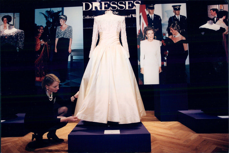 Taggarty Patrick on Christie adjusts one of the total 80 dresses Princess Diana sells in favor of various research projects. - Vintage Photograph