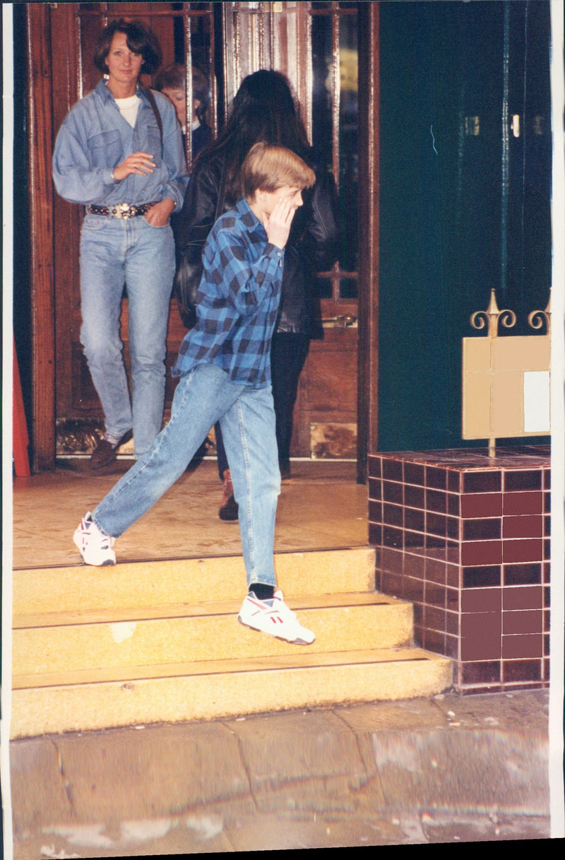 Princess Diana ate dinner at a restaurant with her sons, the princes William and Harry. Picture: William leaves the restaurant. - Vintage Photograph