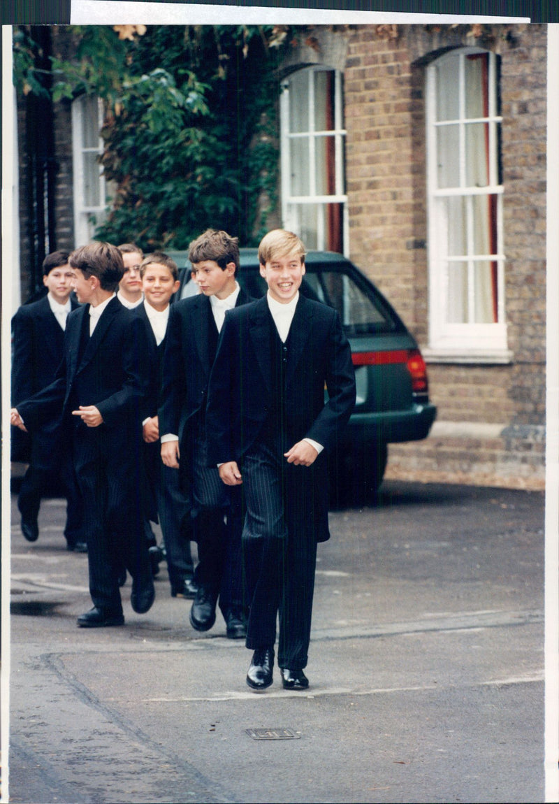 Prince Williams first day at the private school Eton. He wears the traditional uniforms of England's most exclusive school: white tie, coat and striped pants. - Vintage Photograph
