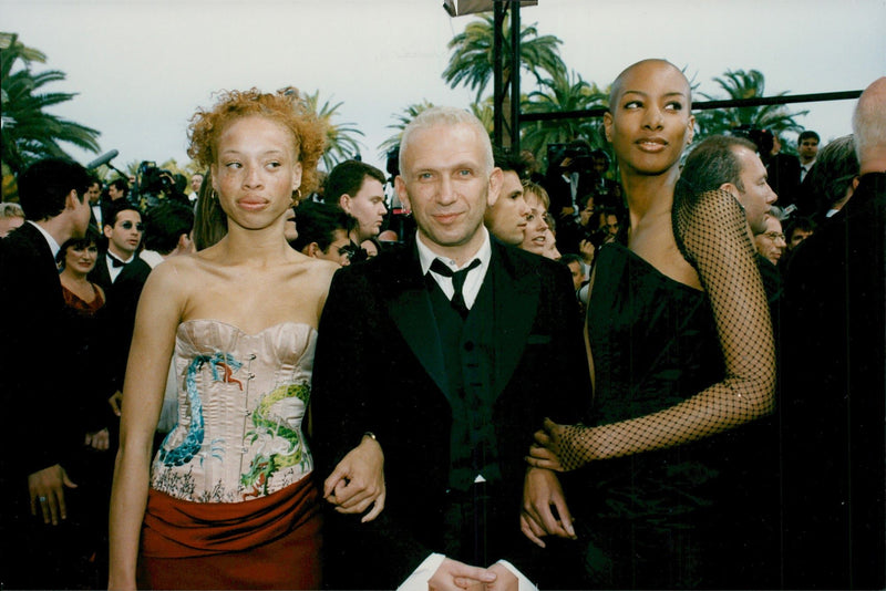 Jean-Paul Gaultier was surrounded by two models at the Cannes Film Festival - Vintage Photograph