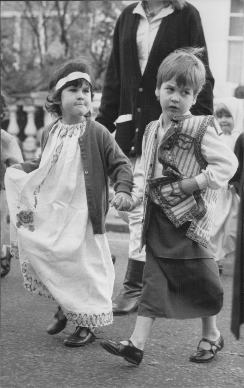 Prince William holds hands with one of his schoolmates during the school's winter paradise - Vintage Photograph