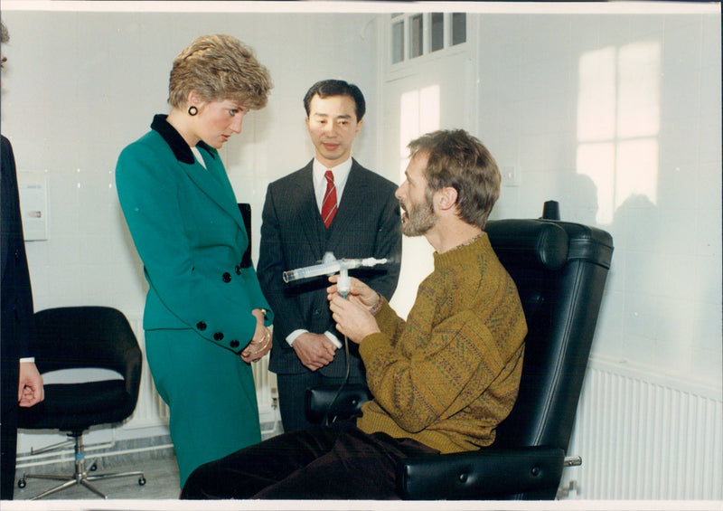 AIDS Center: Princess Diana talks with patient Hugh Clayton while Dr. Carl Chang is watching. - Vintage Photograph