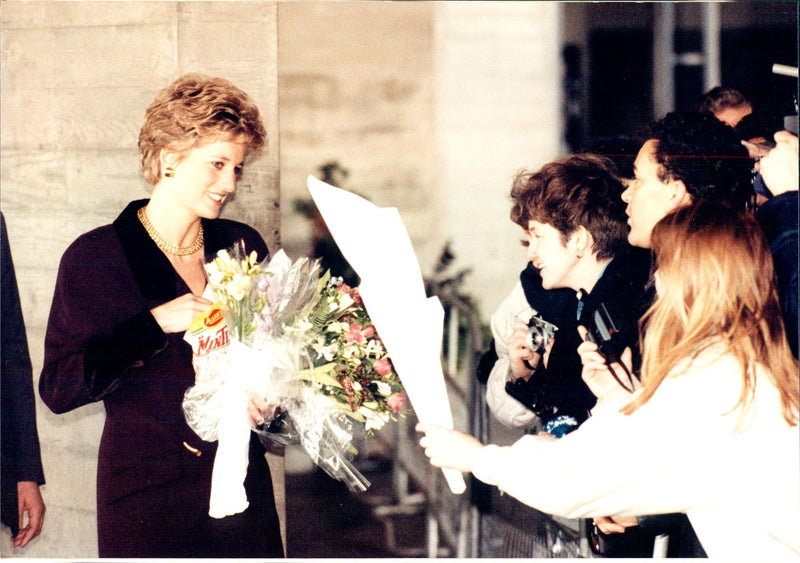 Young admirers received and welcomed Princess Diana. The popular princess always takes time to stop and receive flowers. - Vintage Photograph