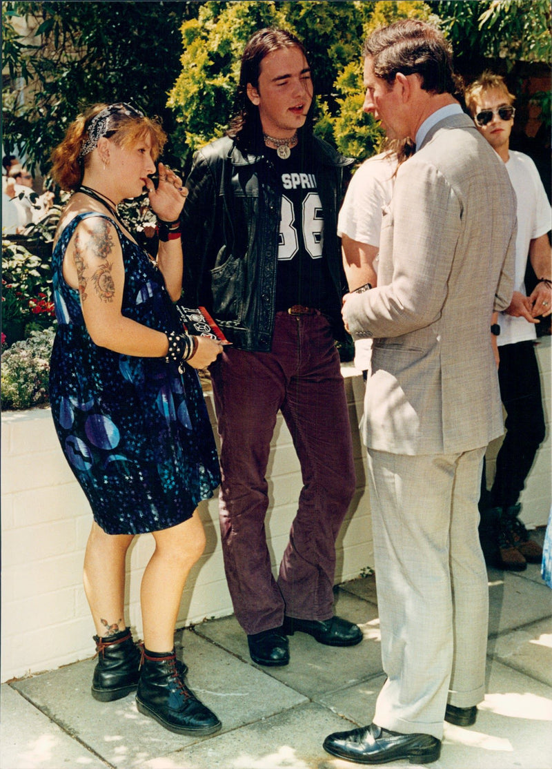 Prince Charles talks with young people during his visit to the "Sidney City Mission", a center that helps homeless and jobless in New South Wales, Australia. - Vintage Photograph