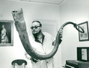 Music Museum. The artist Yngve Gamlin with an old musical instrument called "mÃ¶gla". - Vintage Photograph