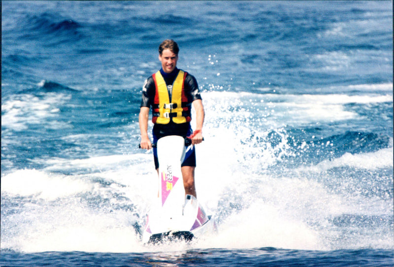 Prince William photographed during his vacation in St Tropez, he goes jet skiing. He was there with his mother, Princess Diana and her brother, Harry. - Vintage Photograph