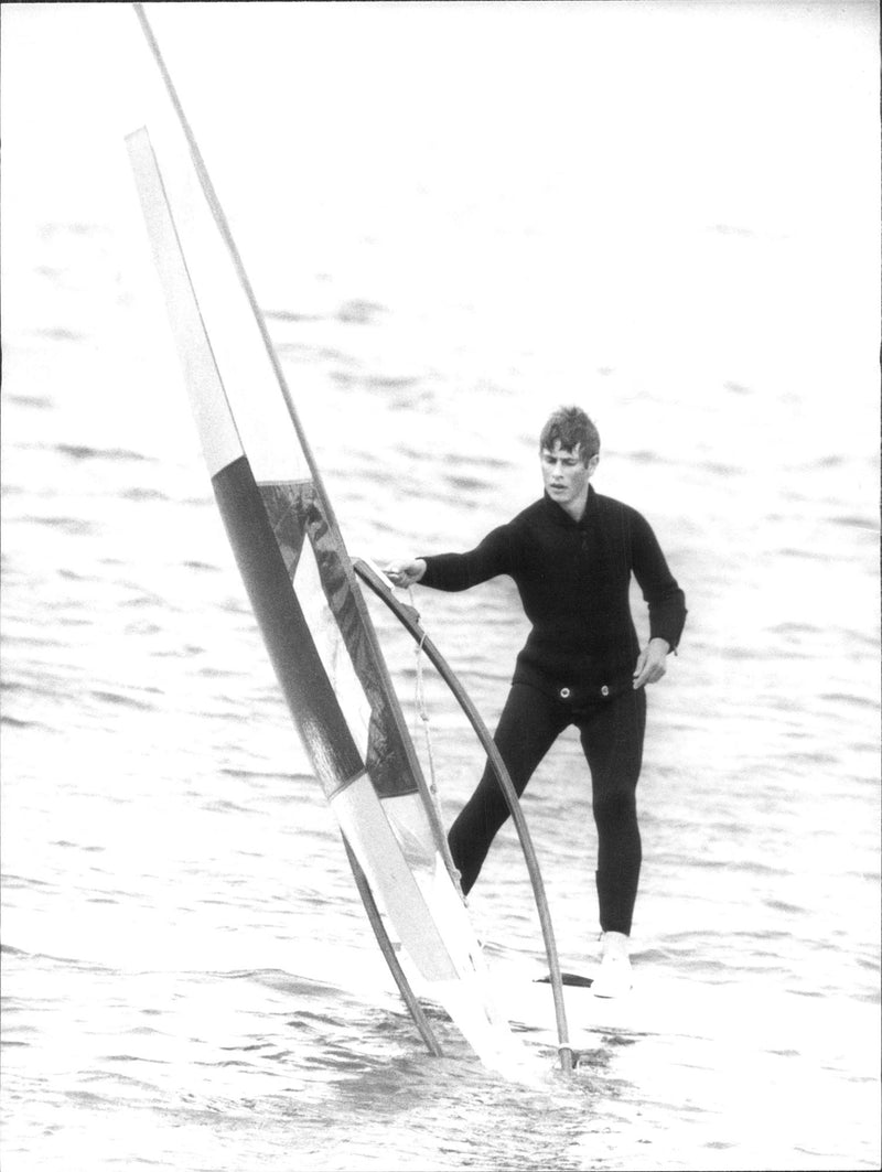 Prince Edvard is testing windsurfing outside Cowes. Prince Charles acted as teacher of his younger brother and ex-King Constantine of Greece. - Vintage Photograph