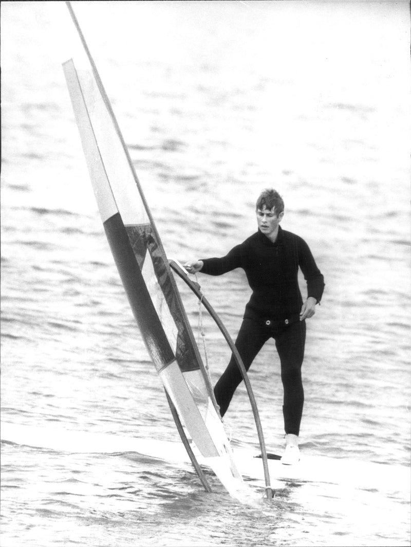 Prince Edvard is testing windsurfing outside Cowes. Prince Charles acted as teacher of his younger brother and ex-King Constantine of Greece. - Vintage Photograph