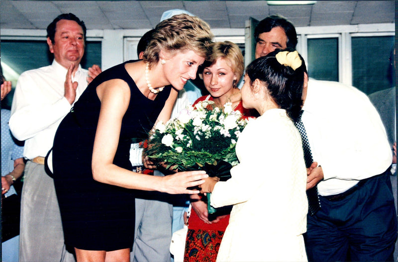 Princess Diana receives flowers by a young patient at the Tushin hospital - Vintage Photograph