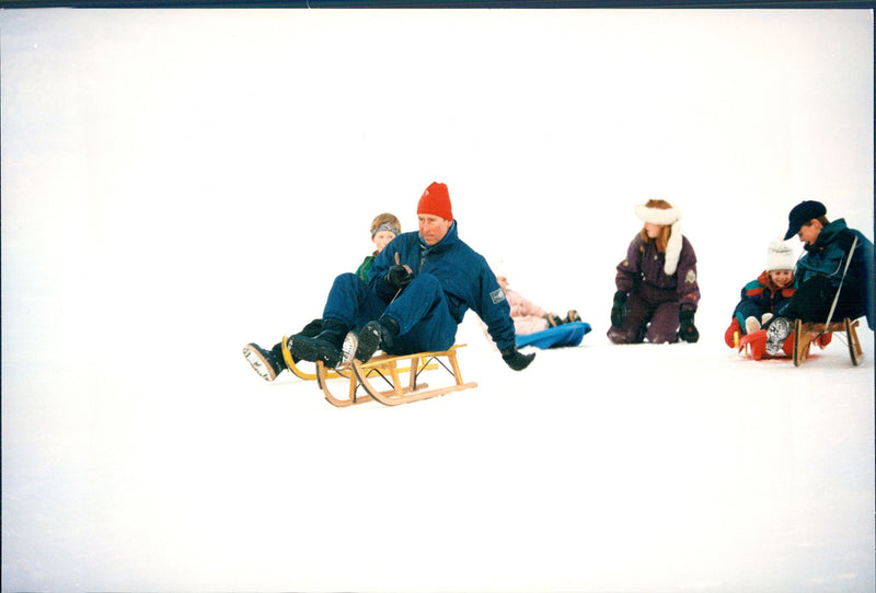 Prince Charles with the sons William and Harry play in the snow with Fergie and her daughters Beatrice and Eugenie - Vintage Photograph