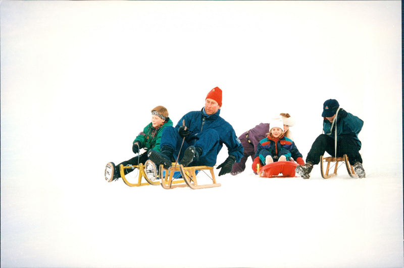 Prince Charles with the sons William and Harry play in the snow with Fergie and her daughters Beatrice and Eugenie - Vintage Photograph