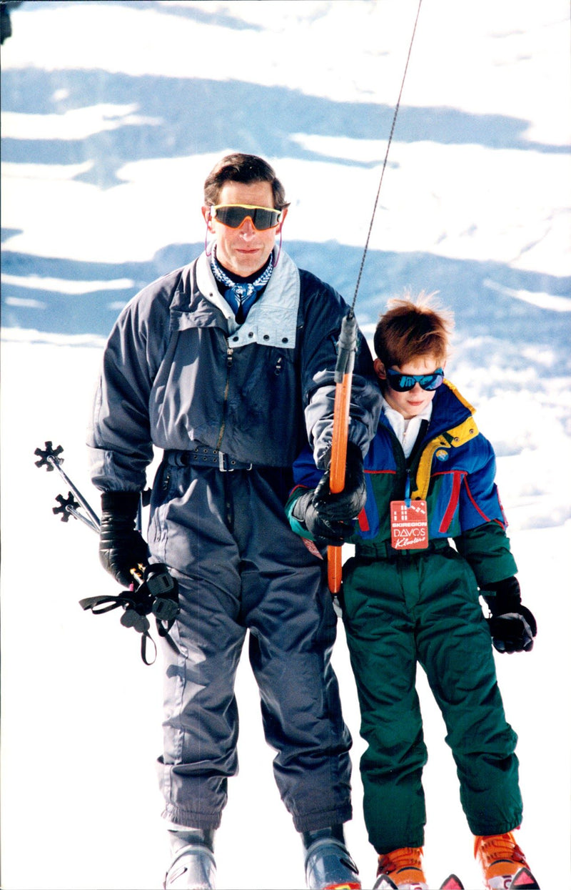 Prince Charles and Prince Harry during a skiing holiday in the Swiss Alps. - Vintage Photograph