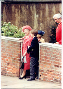 The young princesses William and Harry are aging about their grandmother Queen Elizabeth, the Queen Mother. - Vintage Photograph