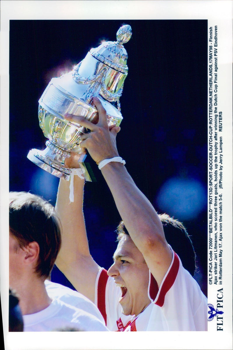 Ajax attack player Jari Litmanen holds up the trophy after the win against PSV Eindhoven - Vintage Photograph