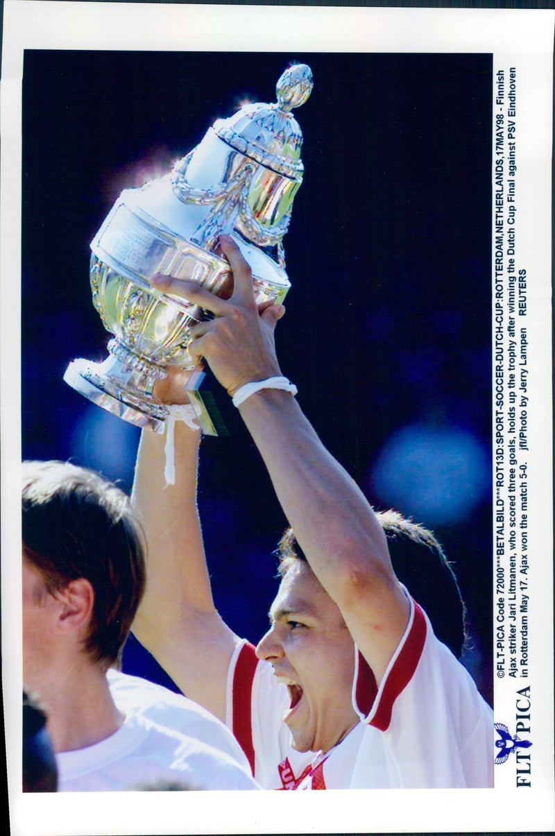 Ajax attack player Jari Litmanen holds up the trophy after the win against PSV Eindhoven - Vintage Photograph