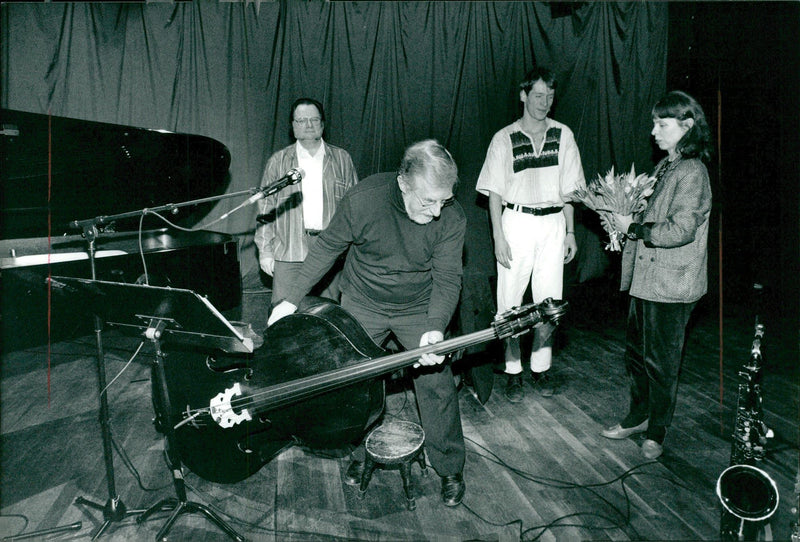 Musician Red Mitchell packs down the instruments after the show in Sweden - Vintage Photograph