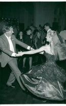 Composer Andrew Lloyd Webber is dancing with Karen Lowe from the musical fantasy of the opera - Vintage Photograph