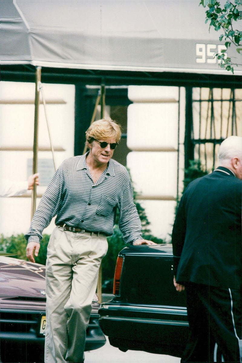 Robert Redford leaves his apartment and goes to the waiting limo on his 58th birthday - Vintage Photograph