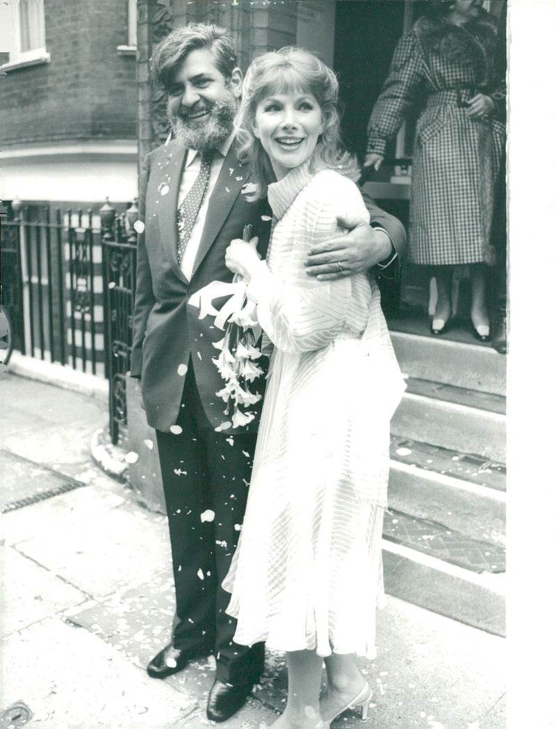 Actress Susan Hampshire and her new husband Eddie Kulukundis at the stairs at the Town Hall after the wedding - Vintage Photograph