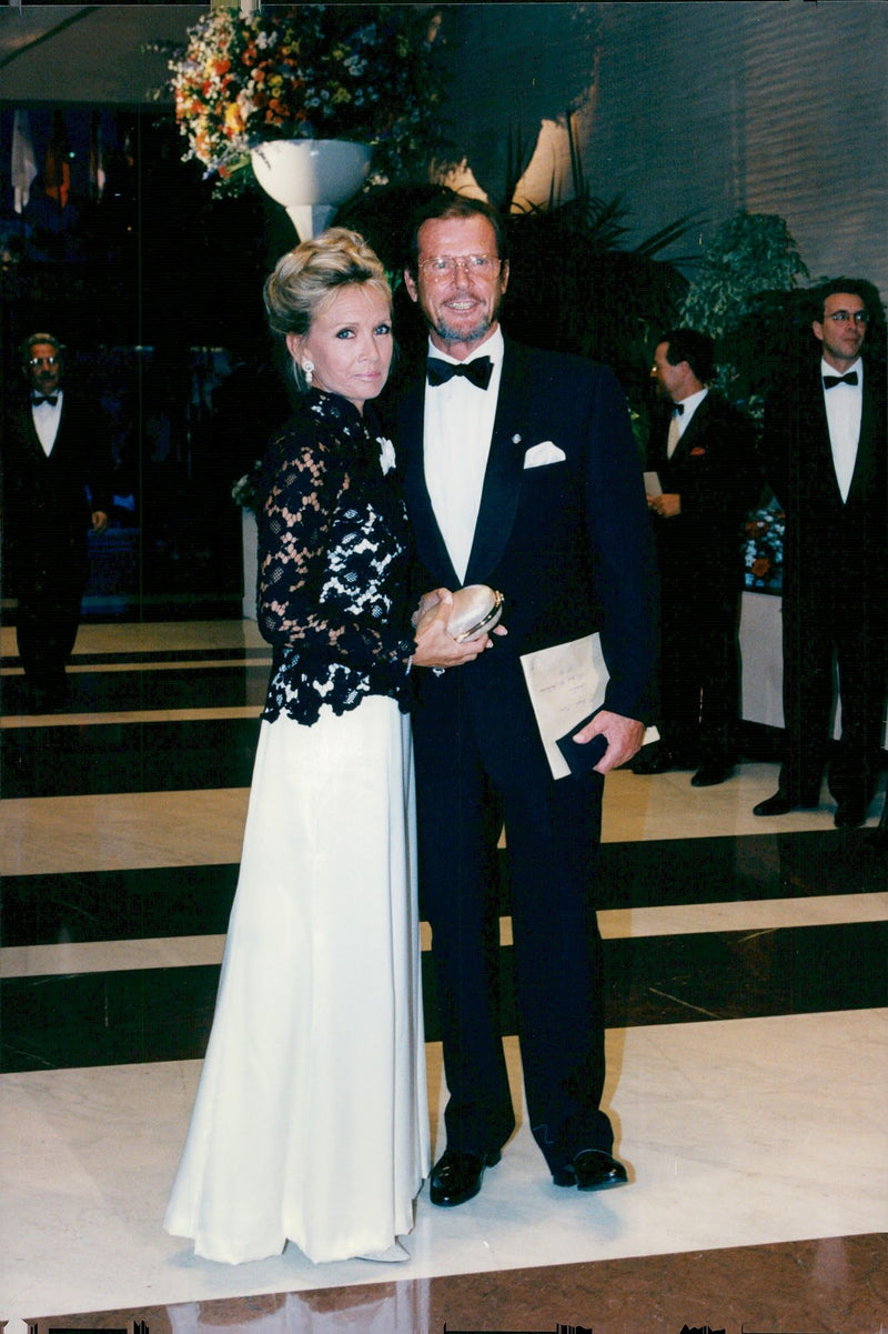 Roger Moore together with girlfriend Kristina Tholstrup during the annual Red Cross bale. - Vintage Photograph