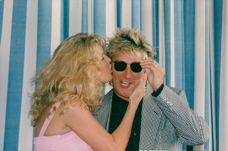 Singer Rod Stewart together with his wife Rachel Hunter at the MIP-TV festival in Cannes. - Vintage Photograph