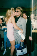 Singer Rod Stewart together with his wife Rachel Hunter at the MIP-TV festival in Cannes. - Vintage Photograph
