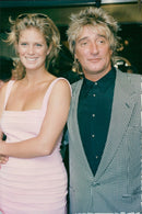 Singer Rod Stewart together with his wife Rachel Hunter at the MIP-TV festival in Cannes. - Vintage Photograph