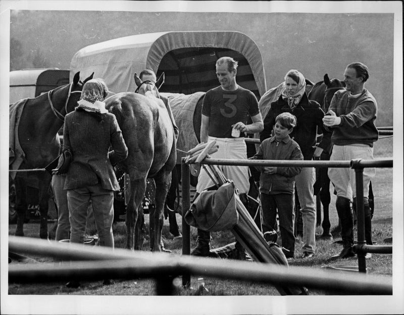 Prince Philip discusses points with his wife Queen Elizabeth II after the match. - Vintage Photograph